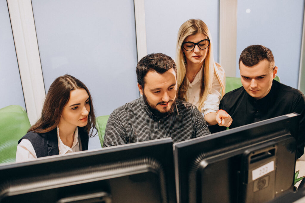 Workers at an IT company working on a computer